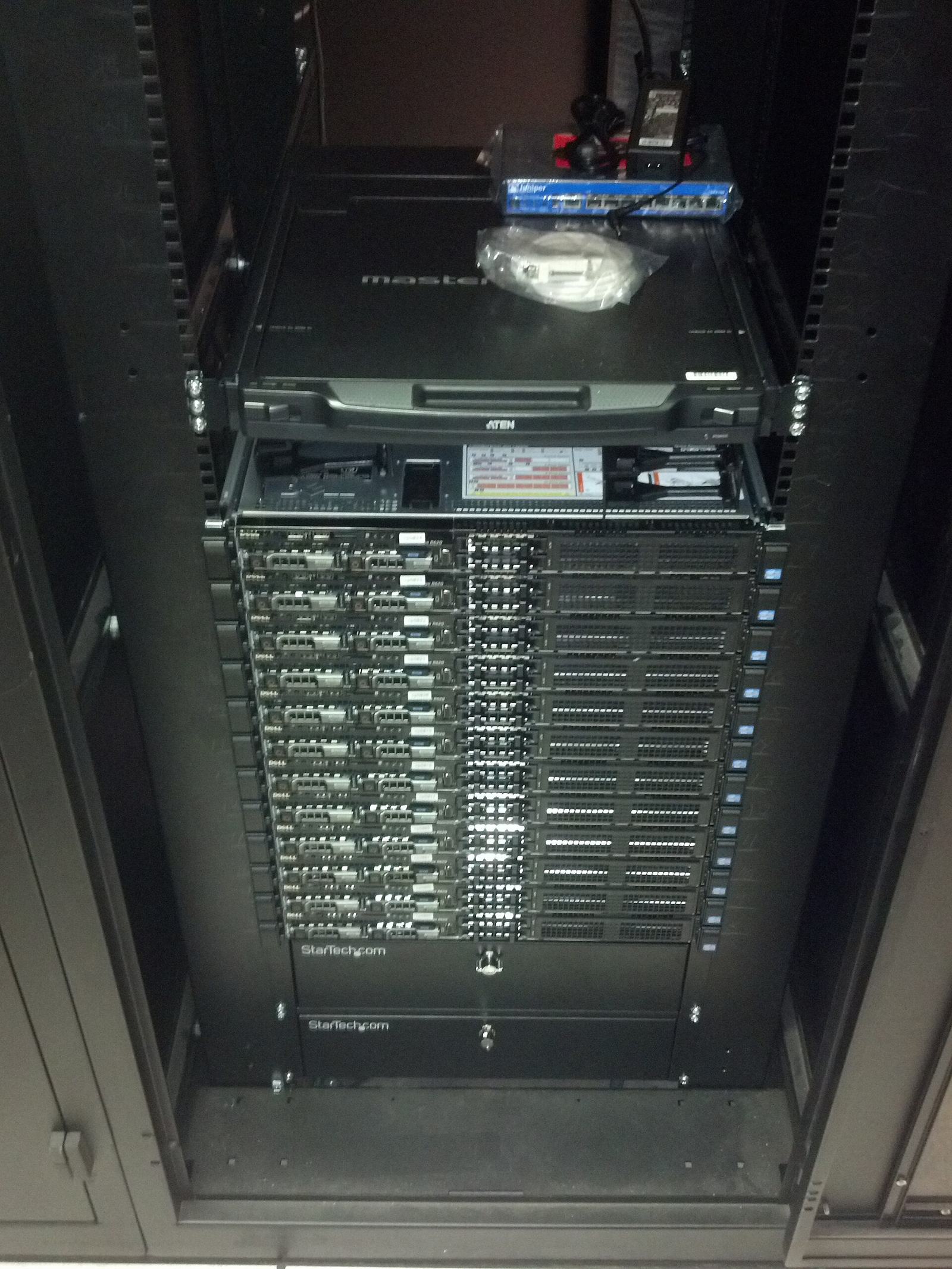 A dark server cabinet with a stack of one-unit servers